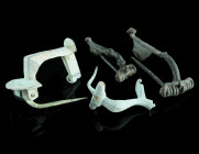 A GROUP OF FOUR ROMAN BRONZE BROOCHES
Circa 1st-3rd century AD.
Two strongly profiled brooches with spring and pin, and two knee brooches with hinged ...