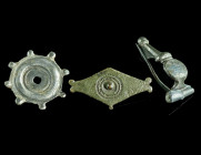 A GROUP OF THREE EARLY ROMAN BRONZE BROOCHES
Circa 1st century AD.
A small, tinned bow brooch with niello decoration and hinged pin; and two small hin...