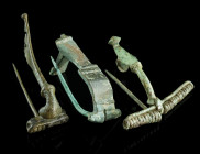 A GROUP OF THREE ROMAN BRONZE BROOCHES
Circa 1st-3rd century AD.
Two strongly profiled brooches with spring and pin, and a knee brooch with hinged pin...