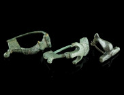 A GROUP OF THREE ROMAN BRONZE BROOCHES
Circa 2nd-3rd century AD.
A bow brooch with an anchor-shaped head, a further bow brooch, and a small knee brooc...