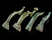 A GROUP OF FOUR ROMAN BRONZE WOLF HEAD BROOCHES
Circa late 1st-2nd century AD.
Four bow brooches decorated with a stylised wolf's head. All hinged, pi...