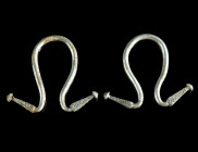 A PAIR OF GREEK SILVER OMEGA EARRINGS
Circa late 6th-5th century BC.
Matching pair of earrings, taking their name from a similarity to the Greek lette...