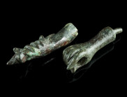 TWO SMALL ROMAN BRONZE LOWER ARMS
Circa 2nd-3rd century AD.
Two right arms. One holding a thunderbolt in the hand, from a statuette of Jupiter; the ot...