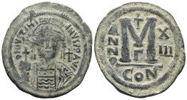 JUSTINIAN I.(527-565).Constantinople.Follis.
Obv : D N IVSTINIANVS P P AVC.
Helmeted, cuirassed bust facing, holding cross on globe and shield with ...