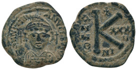 JUSTINIAN I (527-565).Nicomedia.Half Follis.
Obv : D N IVSTINIANVS P P AVG.
Helmeted and cuirassed bust facing, holding globus cruciger and shield d...
