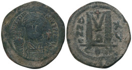 JUSTINIAN I.(527-565).Constantinople.Follis.
Obv : D N IVSTINIANVS P P AVC.
Helmeted, cuirassed bust facing, holding cross on globe and shield with ...
