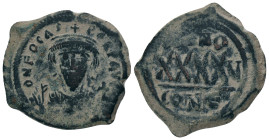 PHOCAS. 602-610 AD. Constantinople mint.AE Follis. DM FOCAE PP AVG, crowned, mantled bust facing, holding mappa and cross / Large XXXX, ANNO above, re...