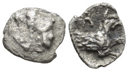 Lykaonia, Laranda AR Obol. Circa 324/3 BC. (9mm, 0,47 g) Baaltars seated left, holding grain ear, grape bunch, and sceptre Rev. Forepart of wolf right...