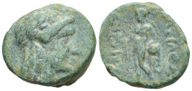 Seleukid Kingdom. Antiochos Hierax. 242-227 B.C. AE (15mm, 3.2 g) head of Apollo right Rev: Apollo standing facing, head left, holding arrow and resti...
