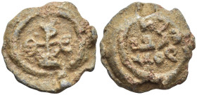 Byzantine Lead Seal, (23mm, 12.6 g) Cruciform monogram;. / Legends in three lines.