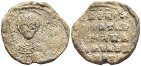 Byzantine Lead Seal, (24mm, 7,7 g) Nimbate facing bust of Saint George, holding spear over his right shoulder and shield on his left arm. / Legends in...