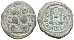 Byzantine  Justin II and Sophia, AE, Follis. (Bronze) Nicomedia. 565-578 AD. Obv: DN IVS[TI]NVS PP AV[G], Justin II and Sophia nimbate and seated on l...