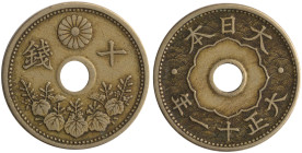 JAPAN: 10 Sen (Year 11 / 1922) in copper-nickel. Flower cartouch around hole and text on a wavy pattern on obverse. Chrysanthemum flower above the hol...