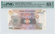 UGANDA: 50 Shillings (ND 1982) in brown, orange and multicolor. Coat of arms at left on face. S/N: "C/16 208644". WMK: Crested Crane. Inside holder by...