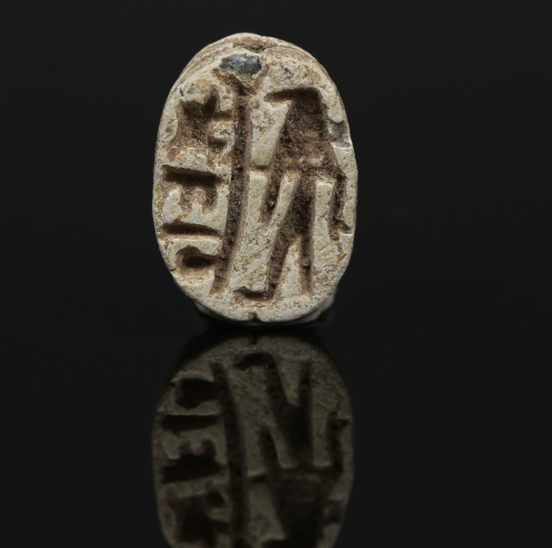 Egyptian scarab with falcon headed deity flanking a crude cartouche “Menkheperre...