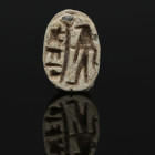 Egyptian scarab with falcon headed deity flanking a crude cartouche “Menkheperre” (Thutmose III)