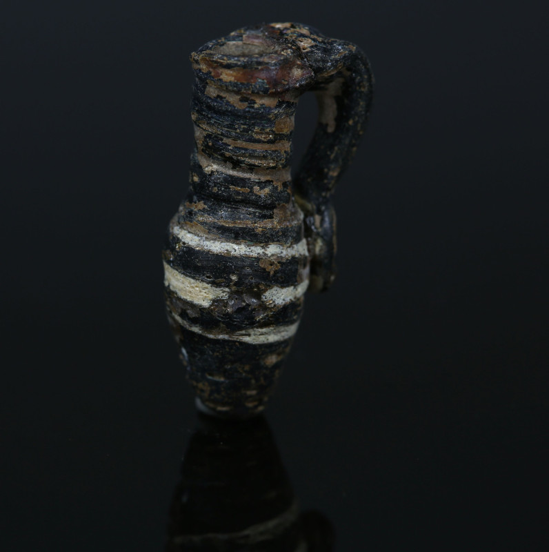 Roman juglet

ITEM: Juglet
 MATERIAL: Glass
 CULTURE: Roman
 PERIOD: 3rd - ...