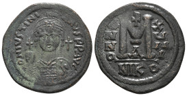 JUSTINIAN I (527-565). Follis. Nicomedia.
Obv: D N IVSTINIANVS P P AVC.
Helmeted and cuirassed bust facing, holding globus cruciger and shield, cross ...
