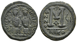 JUSTIN II (565-578). Follis. Nicomedia. 
Obv: D N IVSTINVS P P AVC.
Justin, holding globus cruciger, and Sophia, holding cruciform sceptre, seated fac...