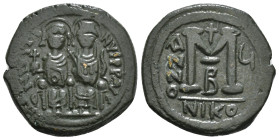 JUSTIN II (565-578). Follis. Nicomedia.
Obv: D N IVSTINVS P P AVC.
Justin, holding globus cruciger, and Sophia, holding cruciform sceptre, seated faci...