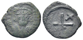 Phocas. AD 602-610. Constantinople Decanummium Æ (16mm., 2,31 g). D FO[CAS PERP AVG], crowned, cuirassed bust facing, holding cross on globe and shiel...