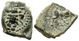 EBUSUS (Ibiza). 1/8 Calco. (Ae. 1,49g/13mm). 200-100 a.C. (FAB-924). Anv: Bes con faldellín de frente con martillo y serpiente. Rev: Toro embistiendo ...