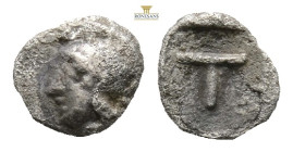 Arkadia, Tegea AR Tetartemorion. Circa 423-400 BC. (0.23g, 6.7 5h.) Head of Athena Alea to left, wearing crested Attic helmet / Large T within shallow...