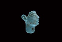 Egyptian Turquoise Glass Face Inlay
Ptolemaic Period, 3rd-1st century BC. A turquoise glass inlay of a profile head with raised eyebrow and eye-line,...