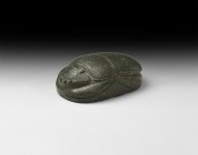 Large Egyptian Carved Stone Scarab
New Kingdom, 1550-1070 BC. A large carved greenstone scarab with plain carapace and incised legs; blank underside....