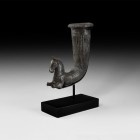 Greek Silver Horse Rhyton
4th century BC. A silver rhyton comprising a fluted tubular curved body with rolled rim and lotus-flower detailing, and a p...