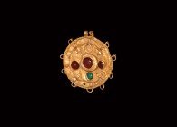 Greek Gold Jewelled Pendant
5th-3rd century BC. A sheet gold discoid pendant with granulated rim and applied radiating loops, concentric applied ring...