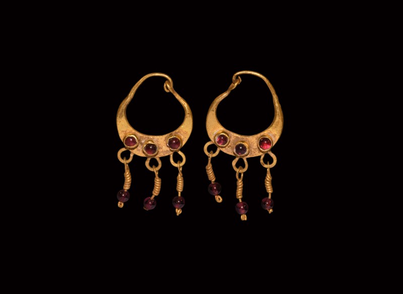 Parthian Gold Earrings with Garnet Drops
1st century BC. A matched pair of gold...