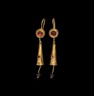 Parthian Gold Earring Pair
1st-2nd century AD. A matching pair of gold earrings with S-shaped hook, formed as a round plaque with inset garnet caboch...