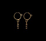 Large Parthian Gold Earring Pair
3rd century BC-2nd century AD. A matched pair of gold earrings, each a substantial hoop with hook-and-eye closure, s...