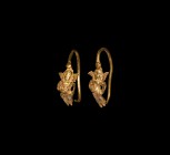 Greek Gold Astarte Earrings
5th century BC. A matched pair of gold figural earrings, penannular with short shank and high-relief facing figure of Ast...