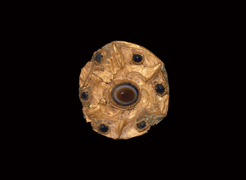 Greek Gold Brooch with Agate Bead
3rd century BC. A gold disc brooch comprising...