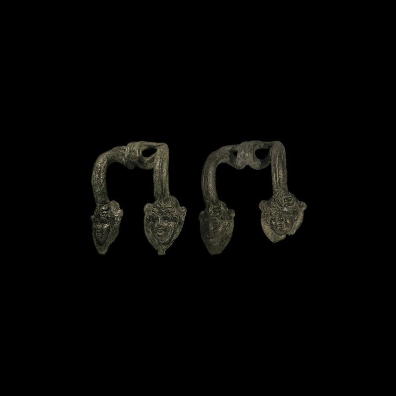 Greek Vessel Handle Pair with Faces
5th-3rd century BC. A matched pair of bronz...