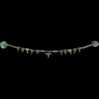 Scythian Necklace String with Animal Head Pendants
6th century BC-3rd century AD. A restrung necklace of wound bronze wire fusiform beads with spheri...