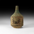 Greek Glazed Vessel with Animals
5th-3rd century BC. A ceramic drum-shaped vessel with remains of green-glaze, with basal ring and conical neck; blac...