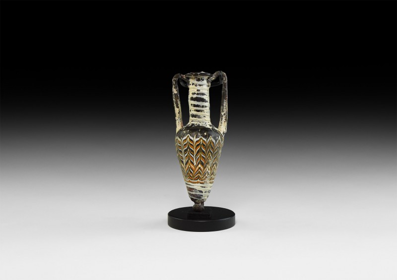 Greek Glass Amphoriskos
5th-3rd century AD. A glass amphoriskos miniature ampho...