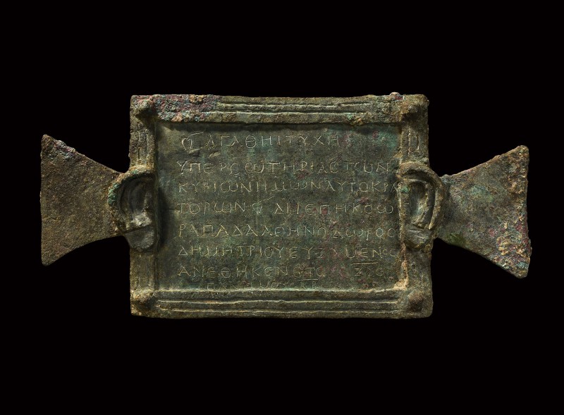 A substantial bronze plaque (tabula ansata), decorated with two human ears and c...