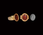Roman Victory Offering Victory Gemstone in Gold Ring
2nd century AD. A carnelian cloison with intaglio seated Victory with spear, shield and helmet, ...