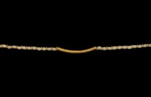 Roman Necklace with Gold Pendant
1st century AD and earlier. A curved gold tubular pendant with flange to each end and circumferential ribbing to the...