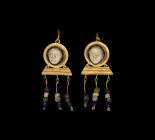 Large Roman Gold Cameo Earring Pair
2nd century AD. A matched pair of gold earrings, each a discoid cell with inset glass cameo female mask, loop to ...