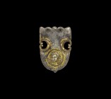 Roman Gilt Silver Strap End with Cupid
2nd-3rd century AD. A silver heater-shaped strap end with gilded voids and scrolls to each side, pierced up ed...