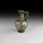 Very Large Roman Green Glass Pitcher
1st century AD. A substantial aqua glass pitcher or jug with slightly eccentric bulbous body, flared base, broad...