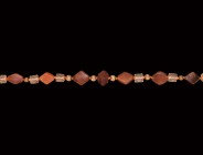 Roman Carnelian and Glass Bead Necklace
2nd-4th century AD and later. A restrung necklace composed of graduated tabular lozengiform carnelian beads, ...