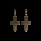 Byzantine Reliquary Cross Pendant with Saints
10th-12th century AD. A hollow-formed bronze reliquary cross pendant with hinge and suspension bulb; ob...