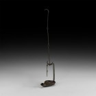 Byzantine Iron Hanging Lamp
10th-12th century AD. An iron hanging oil lamp with a broad funicular trough with narrow curved nozzle; tall curved recta...