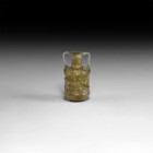 Byzantine Amber-Coloured Mould Blown Vessel
6th-7th century AD. An iridescent mould-blown glass drum-shaped jar with trumpet-shaped mouth, applied st...
